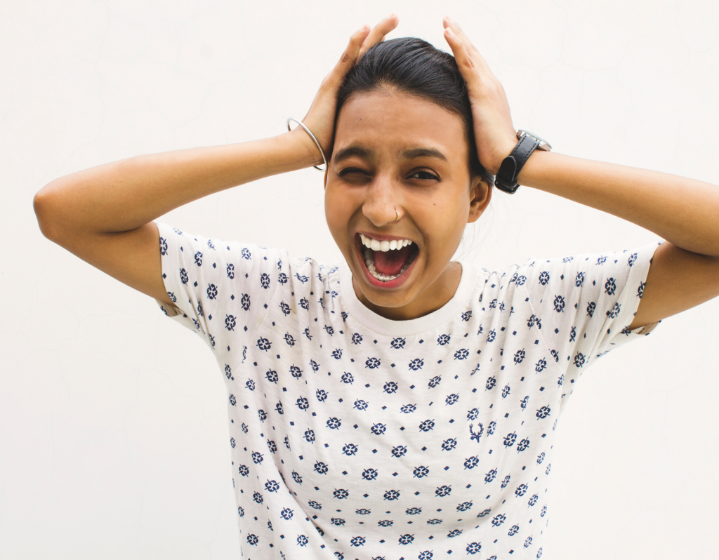 woman yelling holding her head