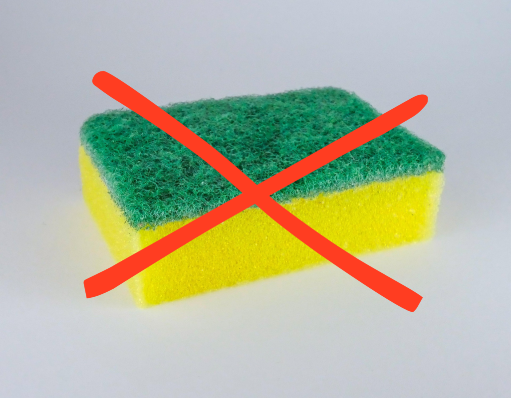 red x over a green and yellow sponge- cleaning hacks, cleaning tips and tricks for moms