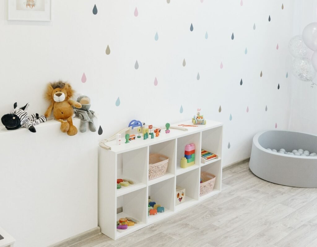 white cubby shelf with 8 cubbies organized neatly with kids toys in a playroom