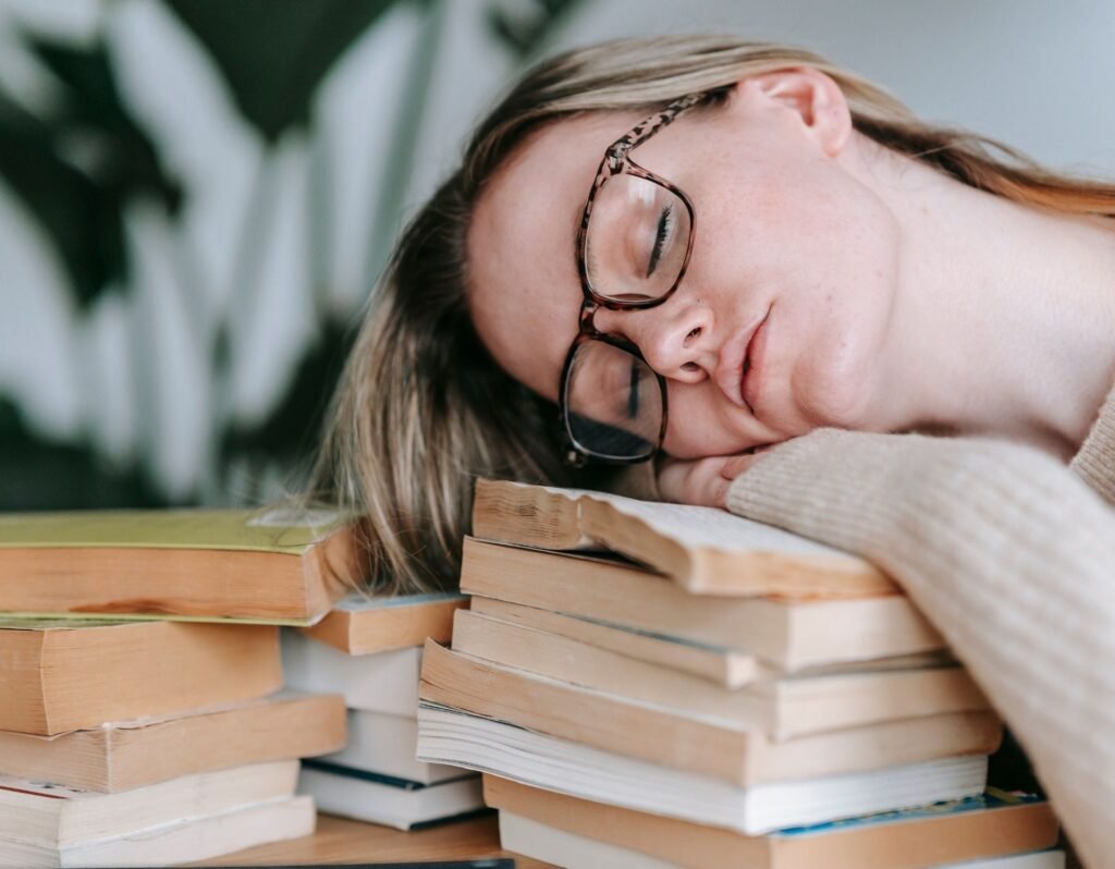 tired chronically ill woman fell asleep on books