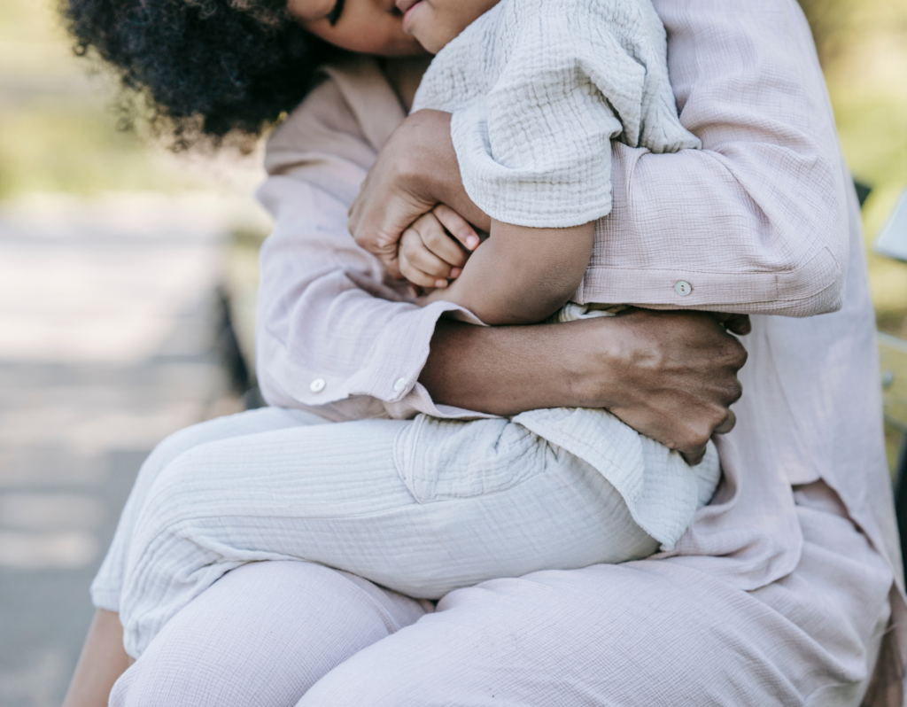 African American mom and son hugging