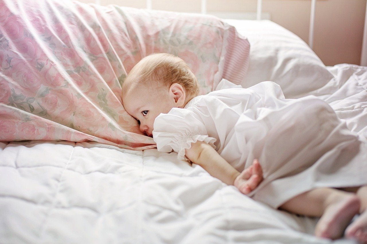 toddler laying awake in bed