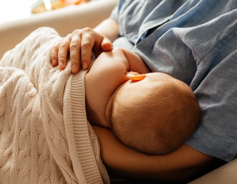 new mom looking for tips on how to help your baby to latch properly the first time. mom holding nursing breastfeeding baby