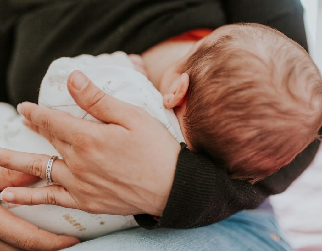 baby breastfeeding with new mom