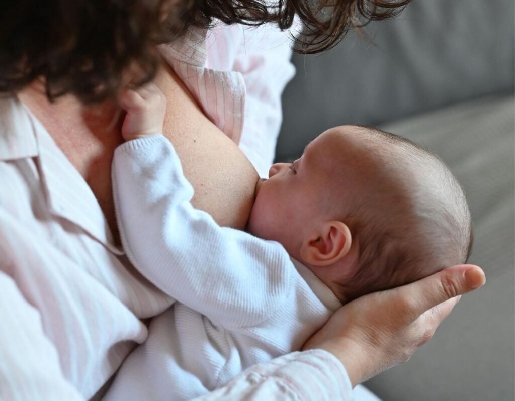 baby breastfeeding with mom at home