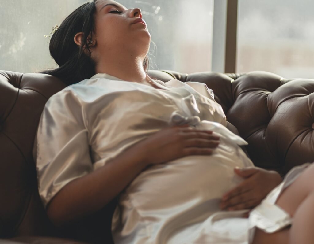 pregnant woman holding her stomach laying down