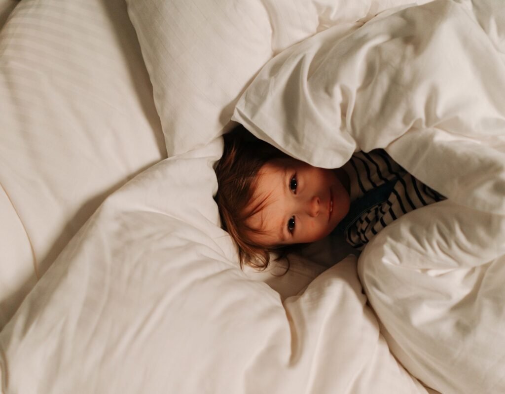 toddler wrapped in blankets- why do toddlers cry when they wake up?