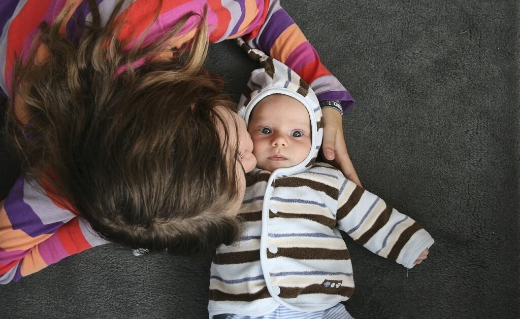 toddler kissing baby